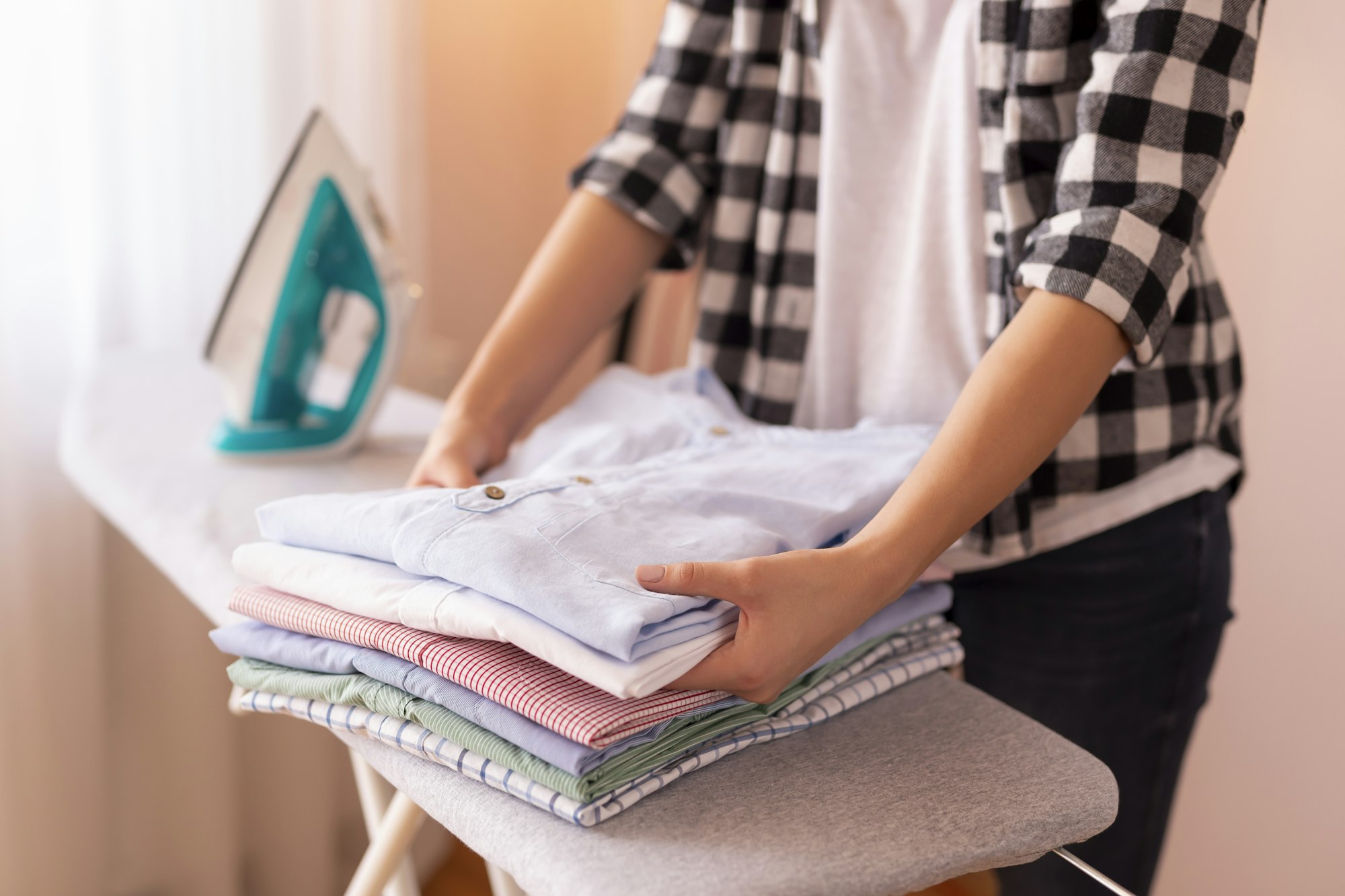 Woman folding clean clothes